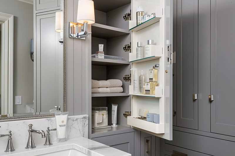a remodeled bathroom featuring custom cabinetry with built-in storage